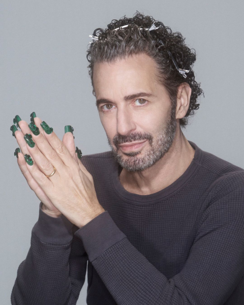 Marc Jacobs posing in a dark longsleeve shirt and long green nails