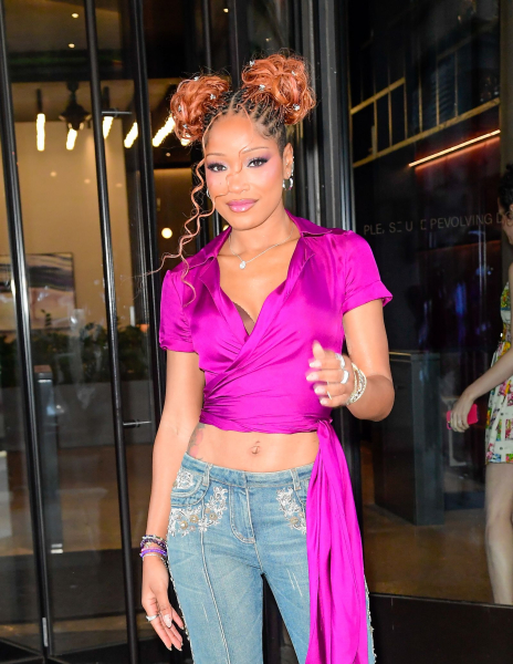 Keke Palmer posing in embroidered jeans and a cropped shirt